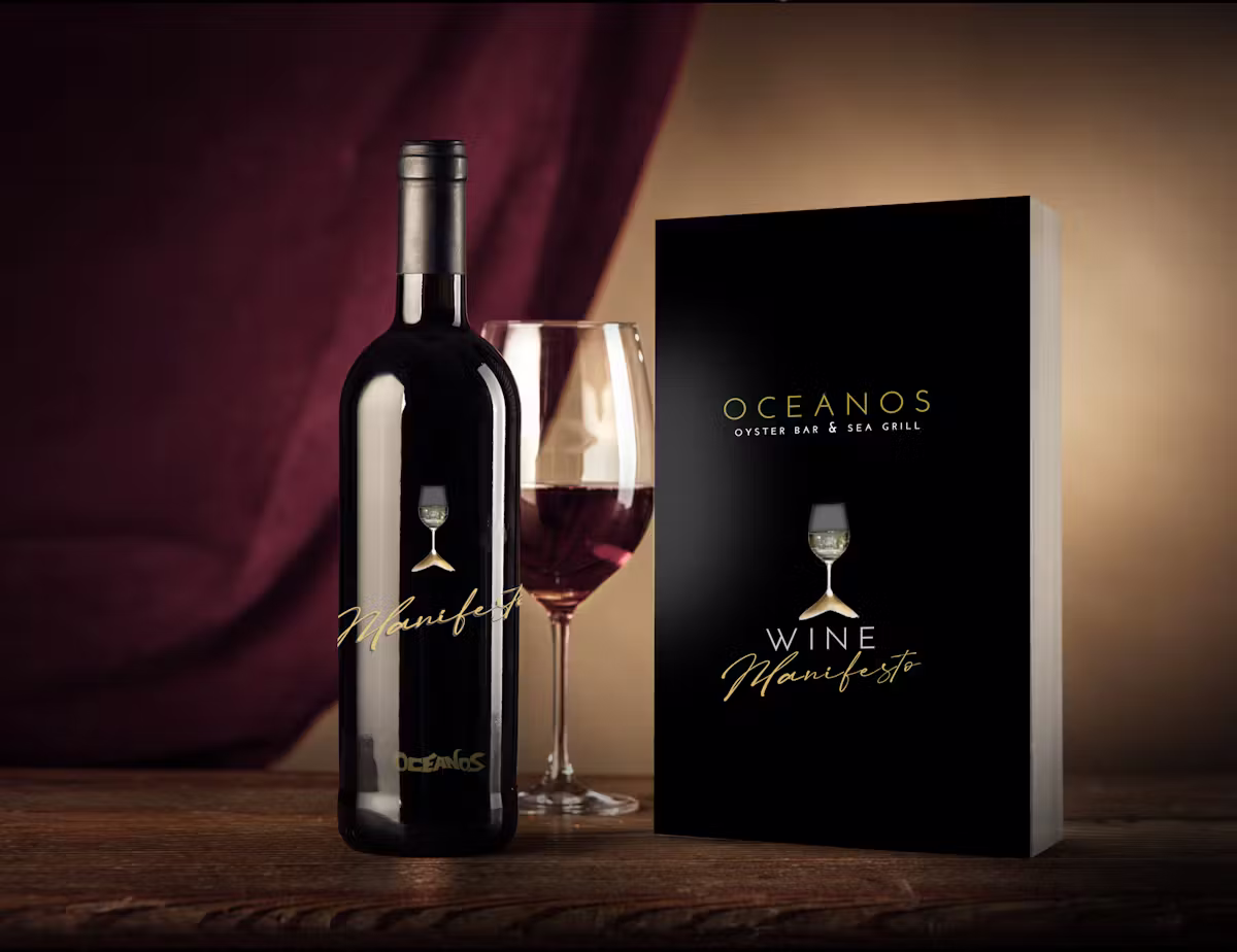 Oceanos book with a bottle of red wine